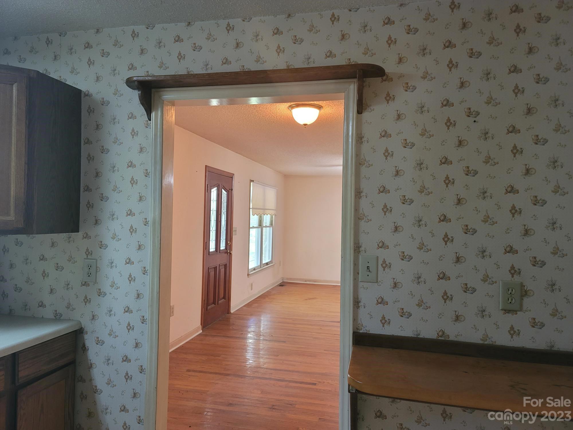 818 St Marks Church Road Bessemer City, NC 28016 - Photo 23 of 48 a view of a hallway with wooden floor and a sink