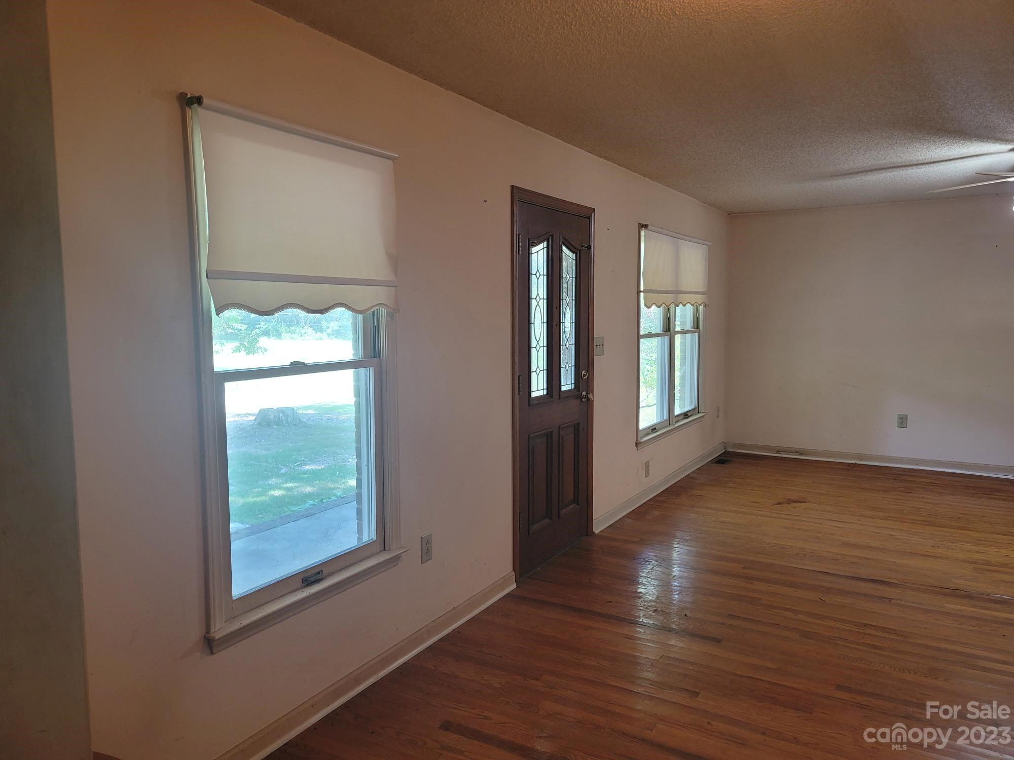 818 St Marks Church Road Bessemer City, NC 28016 - Photo 24 of 48 a view of an empty room with wooden floor and a window