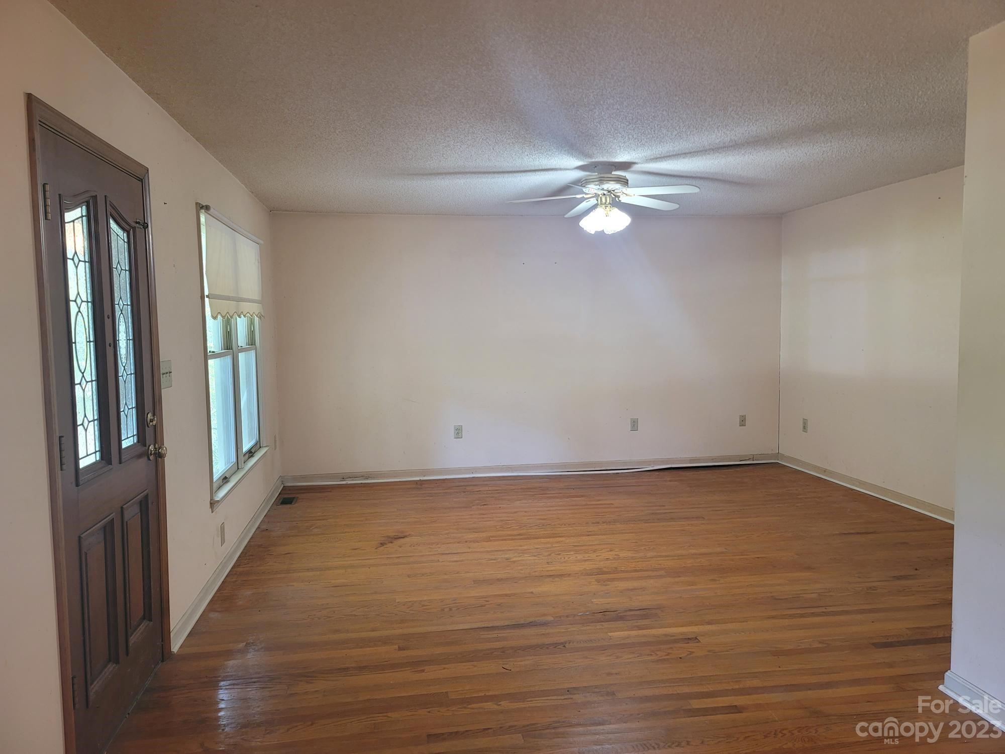 818 St Marks Church Road Bessemer City, NC 28016 - Photo 25 of 48 wooden floor in an empty room with a window