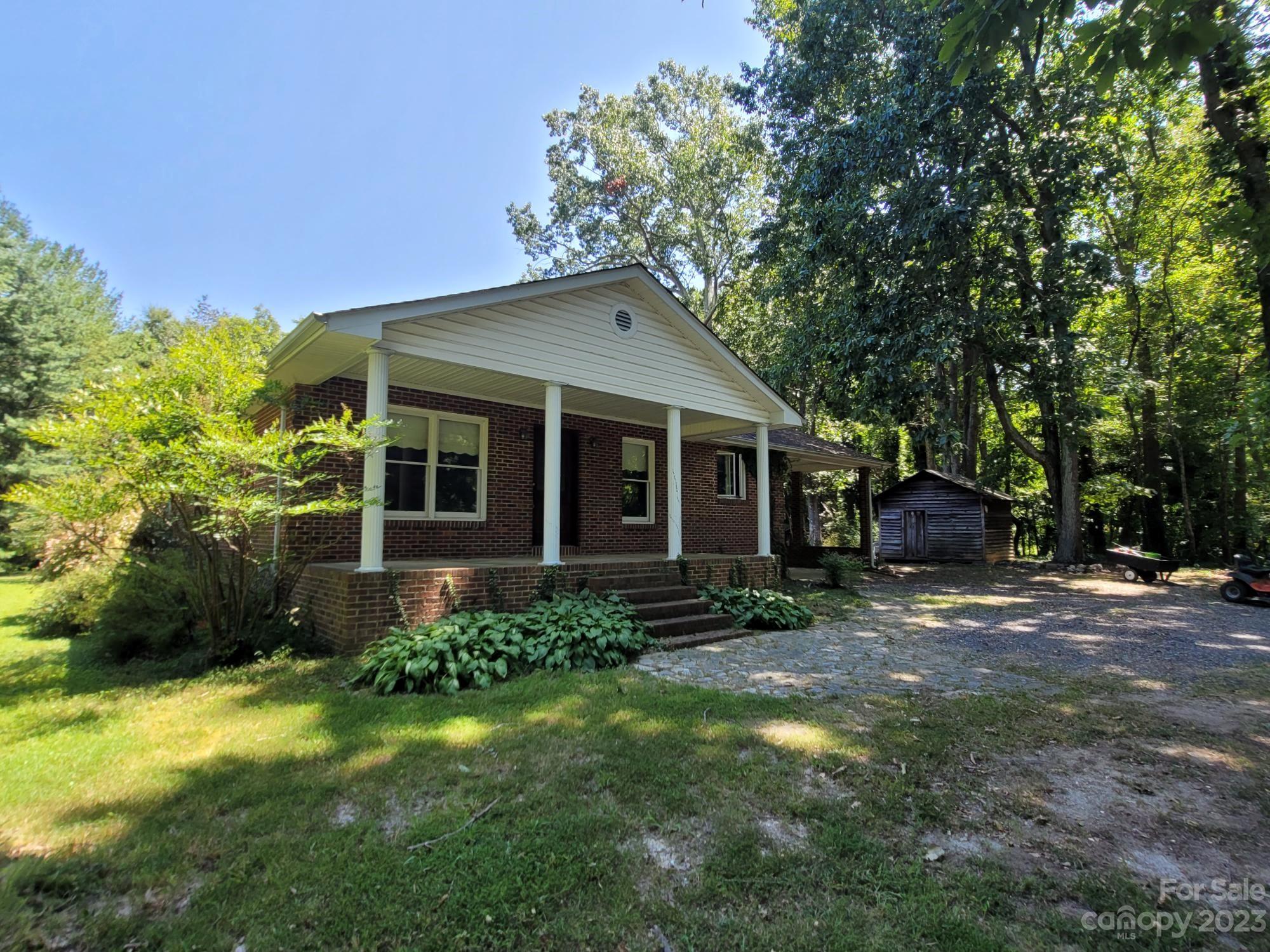 818 St Marks Church Road Bessemer City, NC 28016 - Photo 3 of 48 a front view of a house with garden