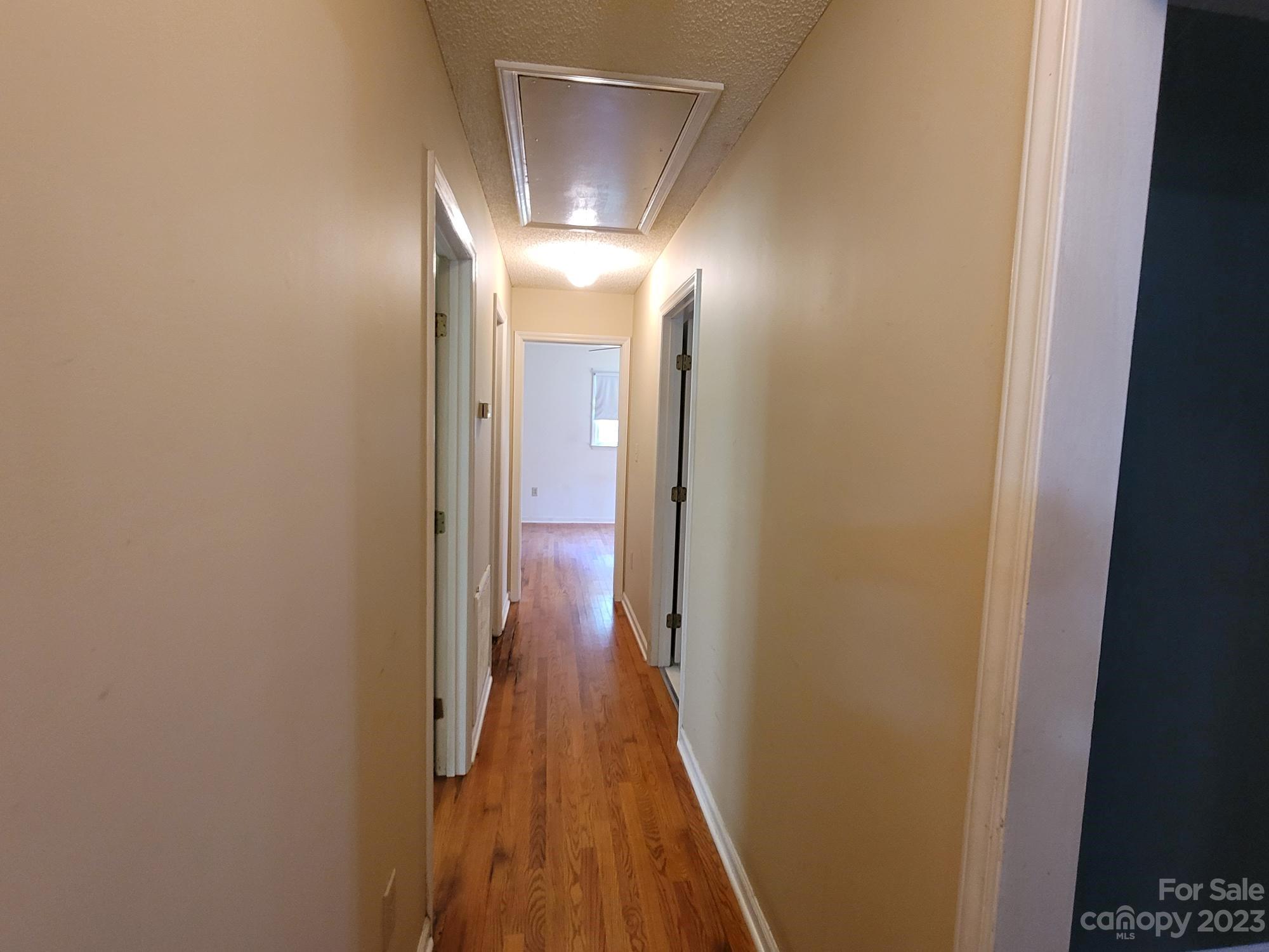 818 St Marks Church Road Bessemer City, NC 28016 - Photo 33 of 48 a view of a hallway with wooden floor