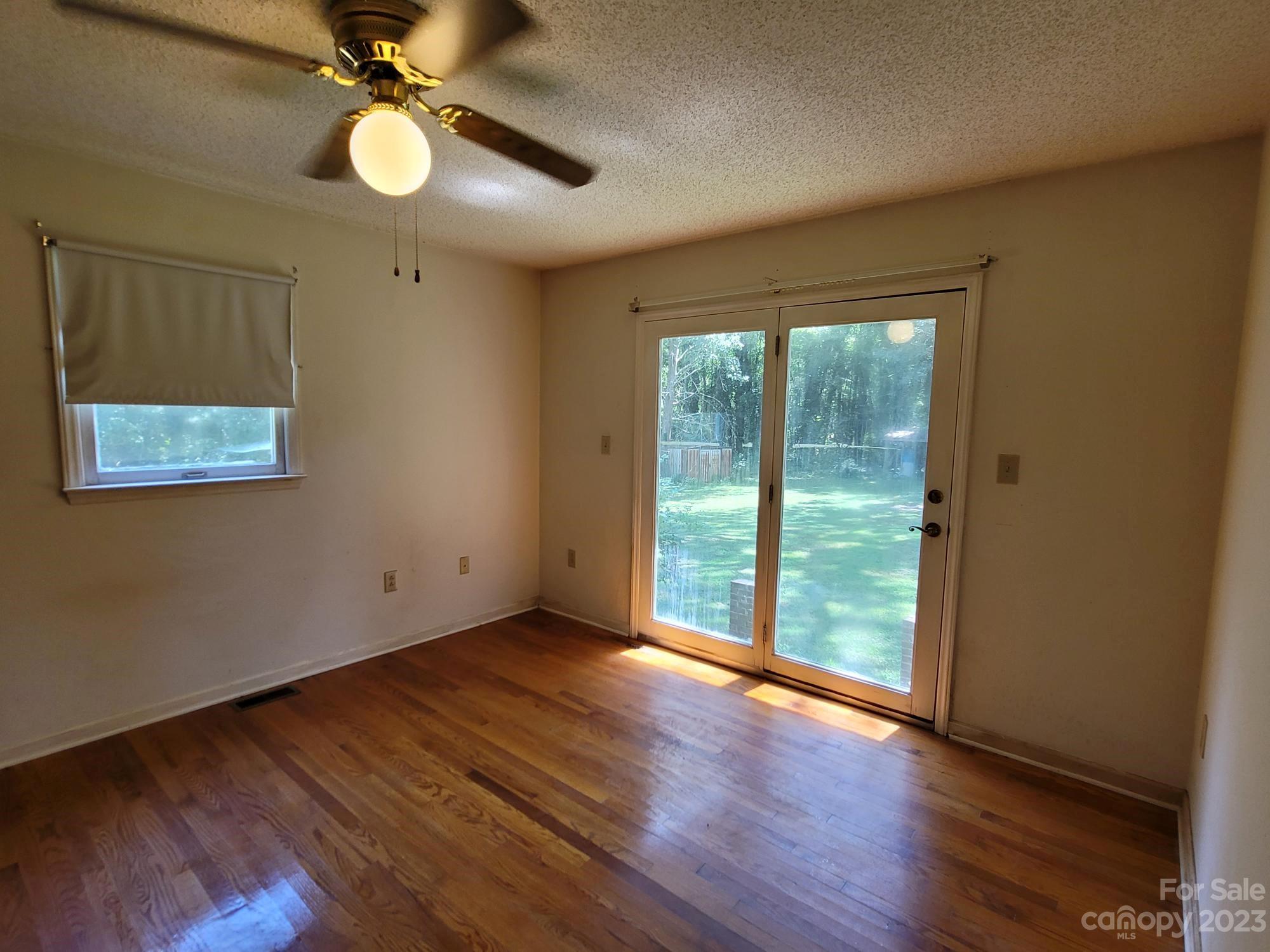 818 St Marks Church Road Bessemer City, NC 28016 - Photo 38 of 48 an empty room with wooden floor and windows