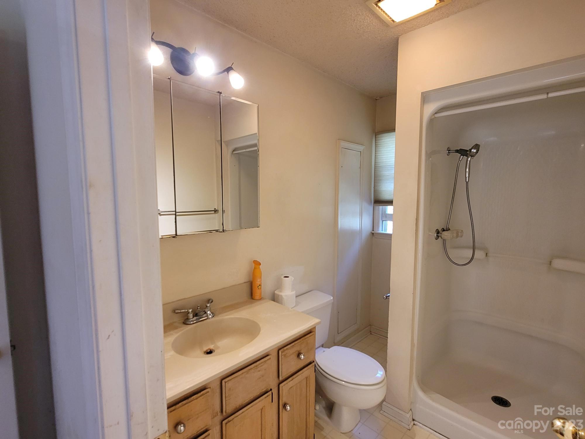 818 St Marks Church Road Bessemer City, NC 28016 - Photo 39 of 48 a bathroom with a granite countertop sink a toilet and shower