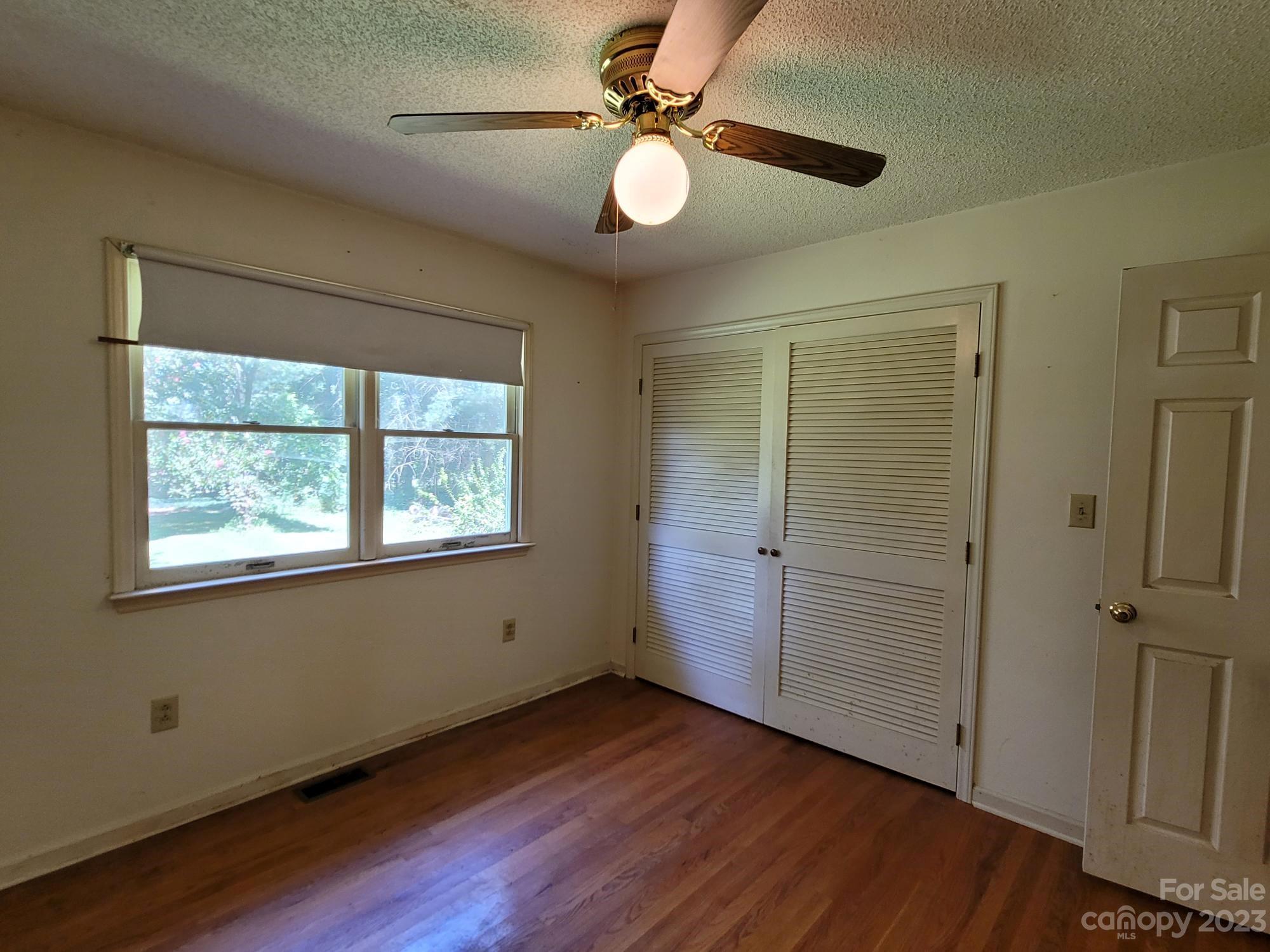 818 St Marks Church Road Bessemer City, NC 28016 - Photo 45 of 48 an empty room with wooden floor and windows