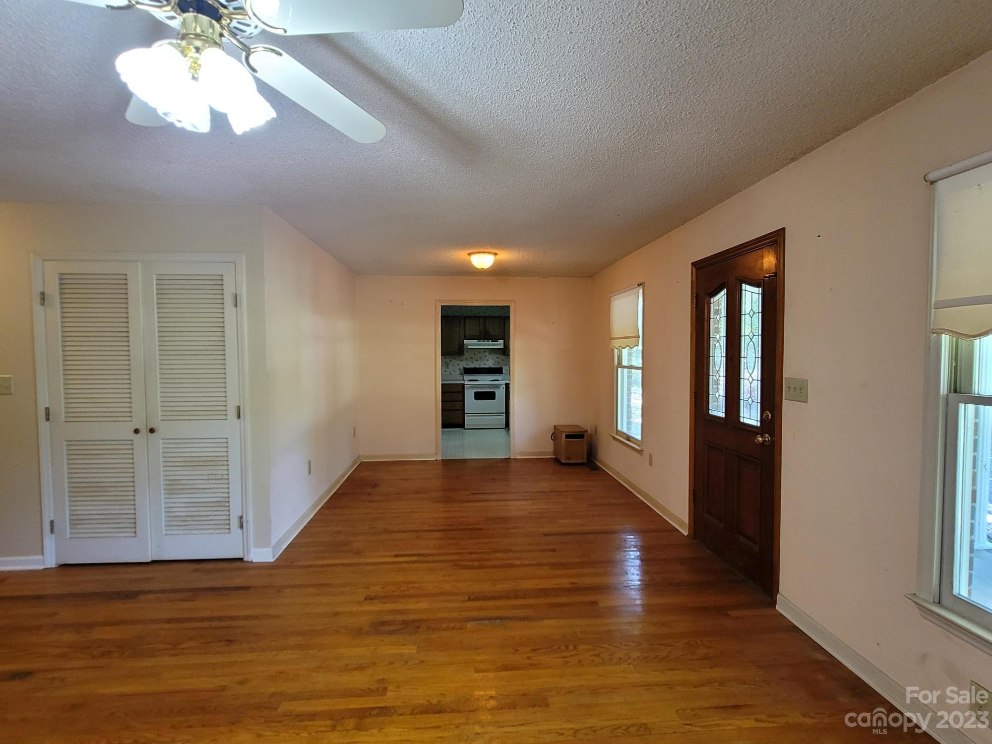 818 St Marks Church Road Bessemer City, NC 28016 - Photo 46 of 48 a view of an empty room with wooden floor and a window
