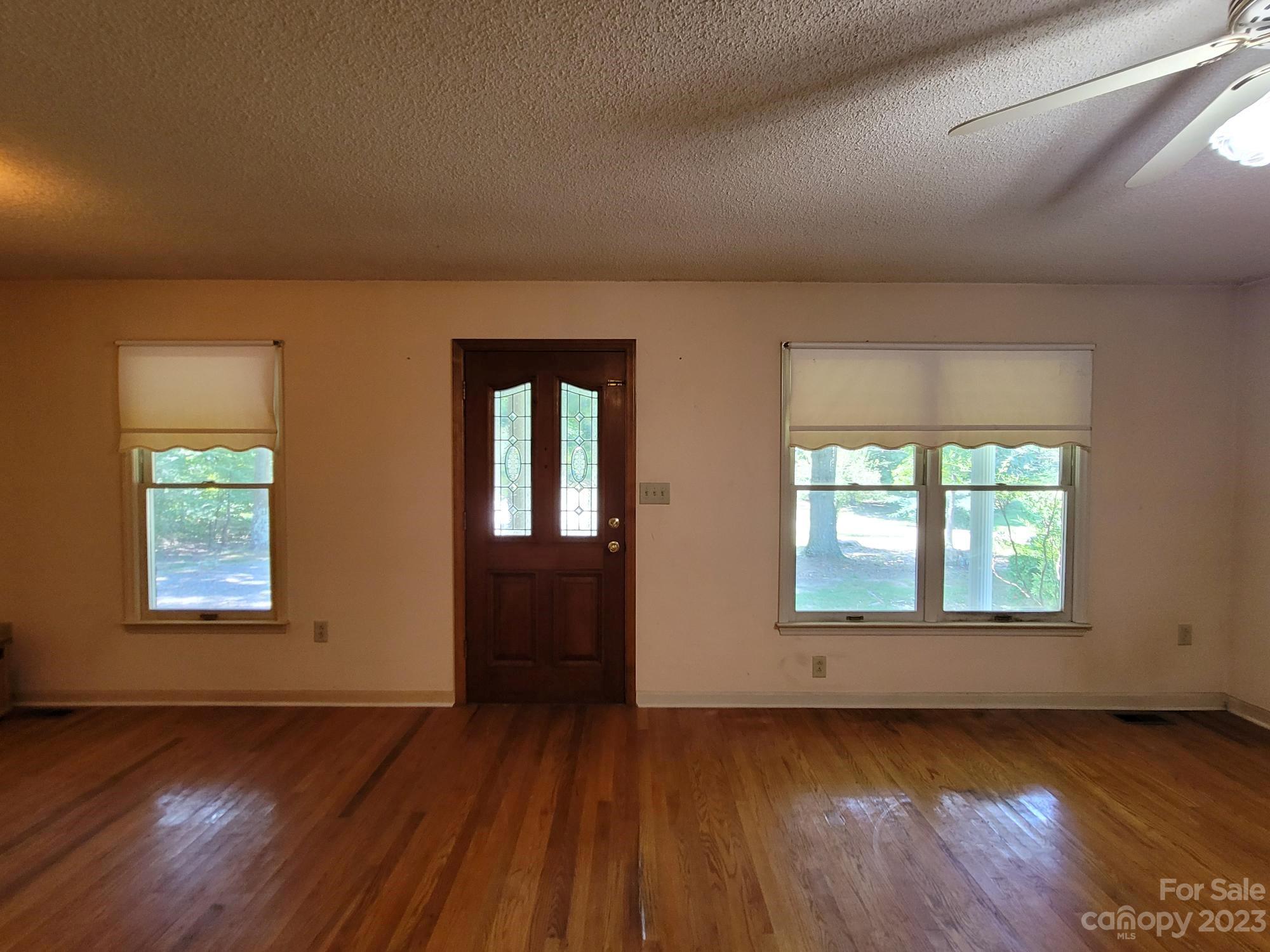 818 St Marks Church Road Bessemer City, NC 28016 - Photo 48 of 48 an empty room with wooden floor and windows