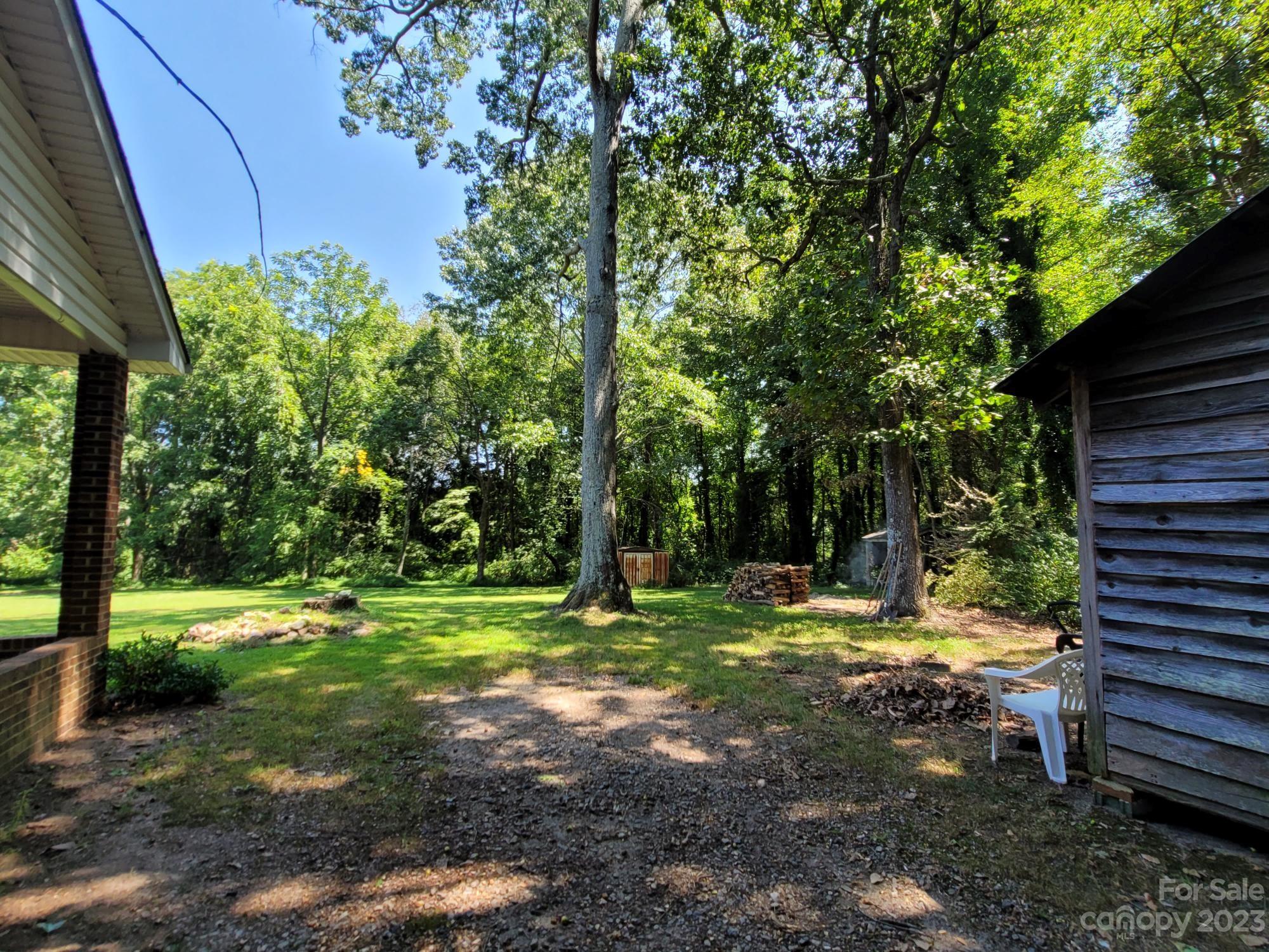 818 St Marks Church Road Bessemer City, NC 28016 - Photo 8 of 48 a backyard of a house with a yard and outdoor seating