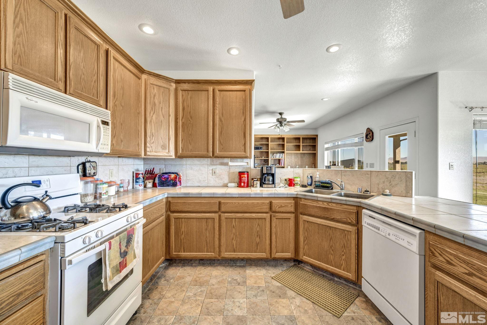 88 Smith Gage Road Smith, NV 89430 - Photo 11 of 40 a kitchen with a sink stove and cabinets