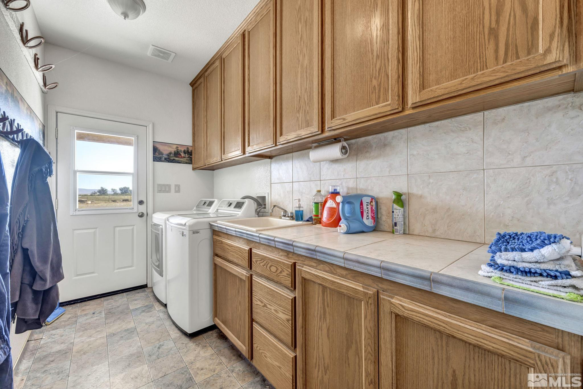 88 Smith Gage Road Smith, NV 89430 - Photo 12 of 40 a kitchen with white cabinets and white appliances