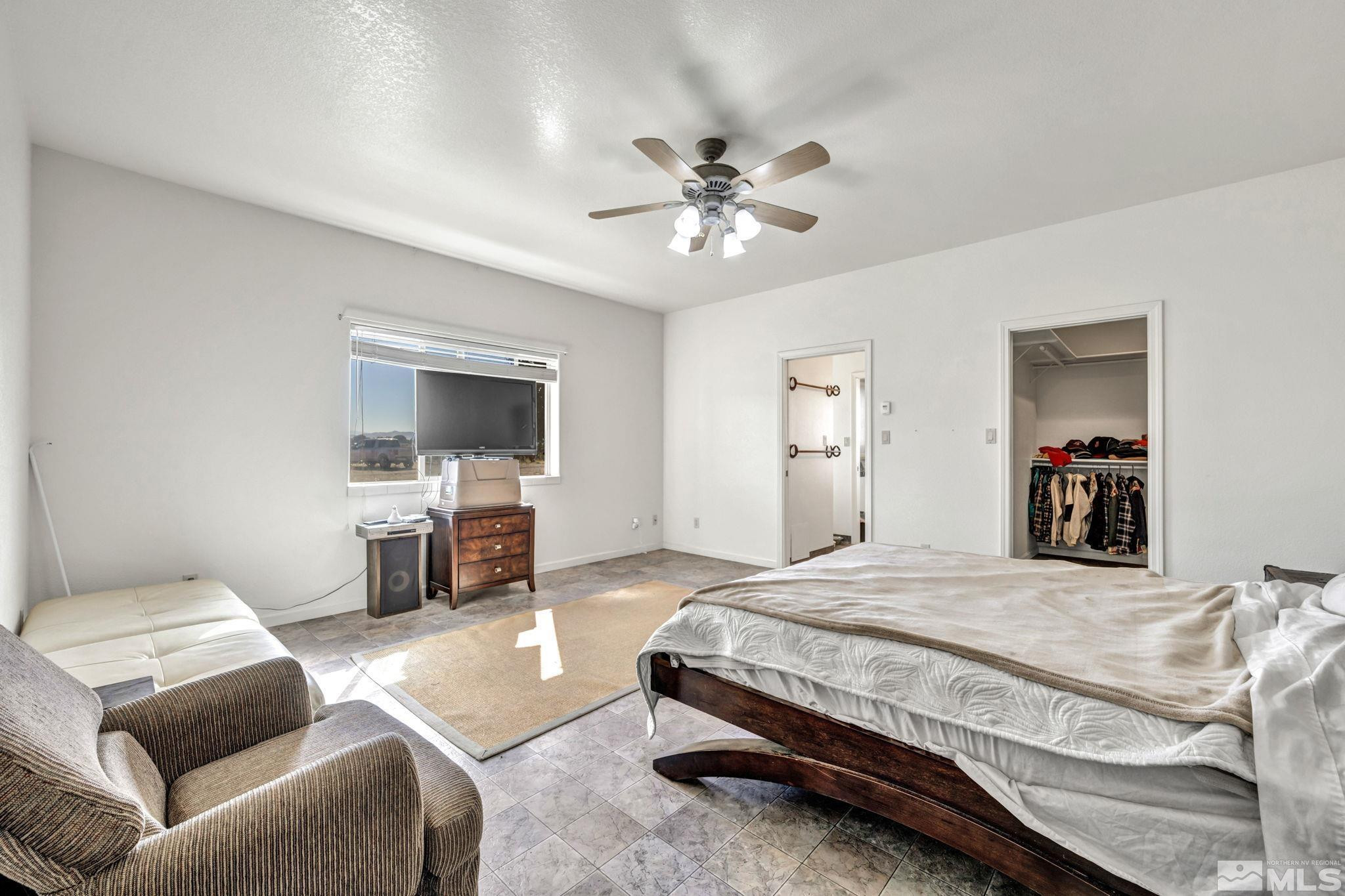 88 Smith Gage Road Smith, NV 89430 - Photo 20 of 40 a bedroom with a bed couch and a flat screen tv