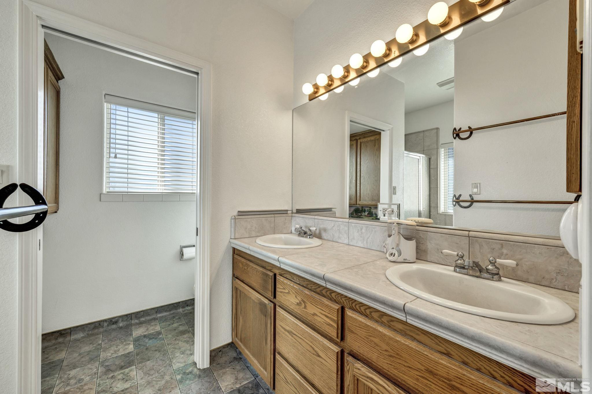 88 Smith Gage Road Smith, NV 89430 - Photo 21 of 40 a bathroom with a sink and a mirror