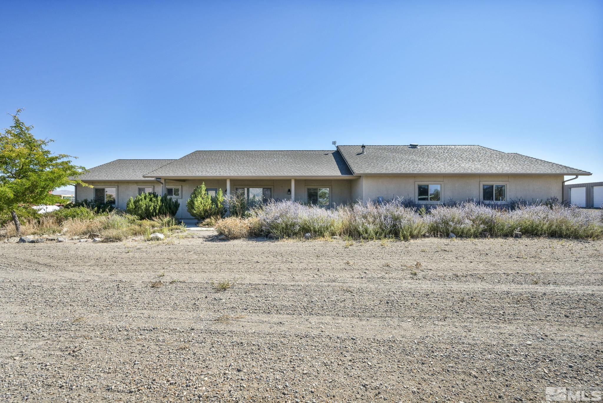 88 Smith Gage Road Smith, NV 89430 - Photo 3 of 40 a front view of house with yard and trees in the background