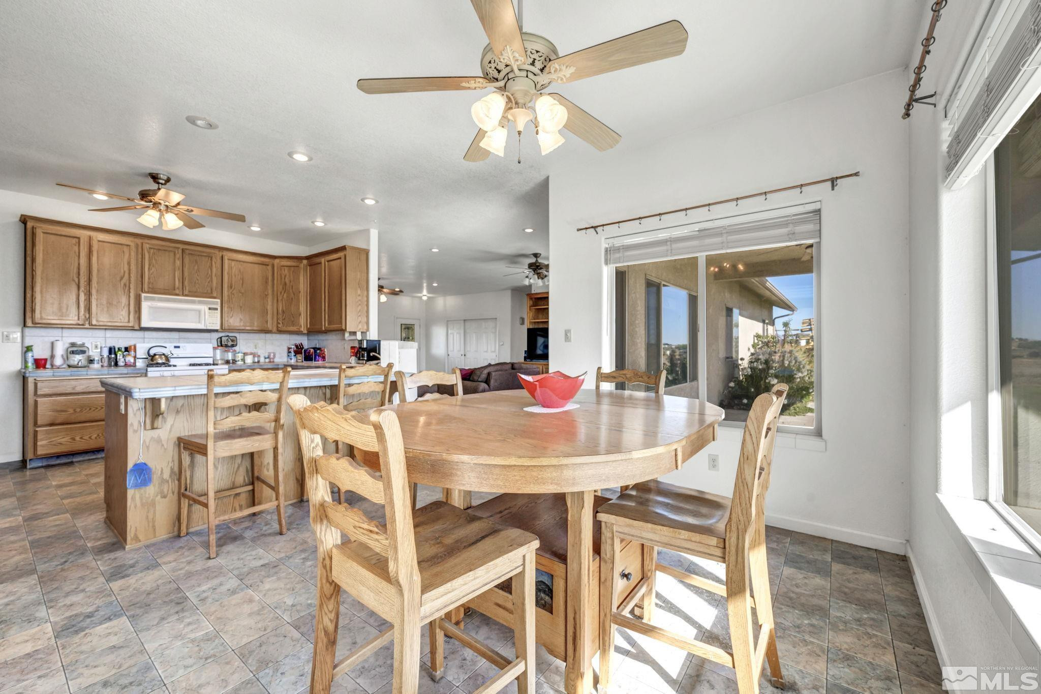 88 Smith Gage Road Smith, NV 89430 - Photo 8 of 40 a view of a dining room with furniture and a chandelier fan
