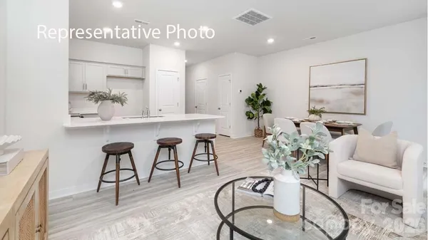 a living room with furniture potted plant and a table