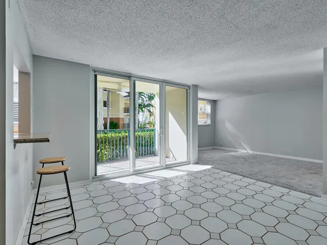 a spacious bedroom with a bed and a chandelier