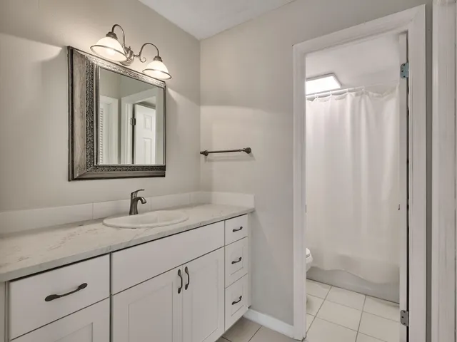 a kitchen with stainless steel appliances granite countertop white cabinets granite counter tops and a stove