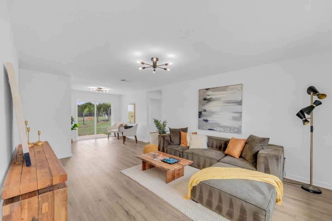 a living room with furniture and wooden floor