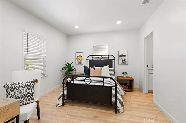 a bedroom with a bed and wooden floor