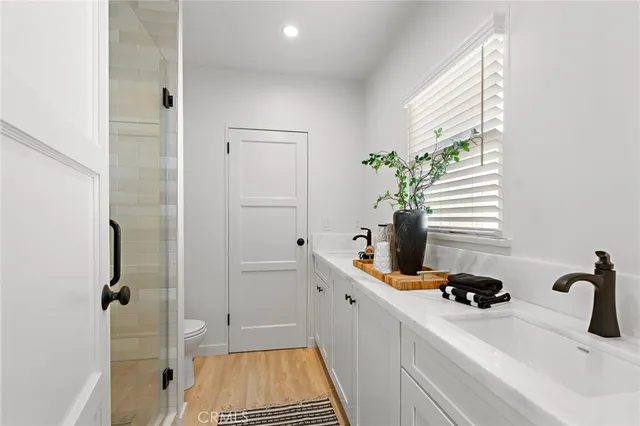a front view of a house with a yard and potted plants