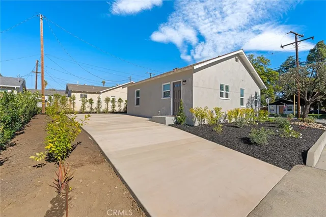 a living room with furniture a rug and white walls