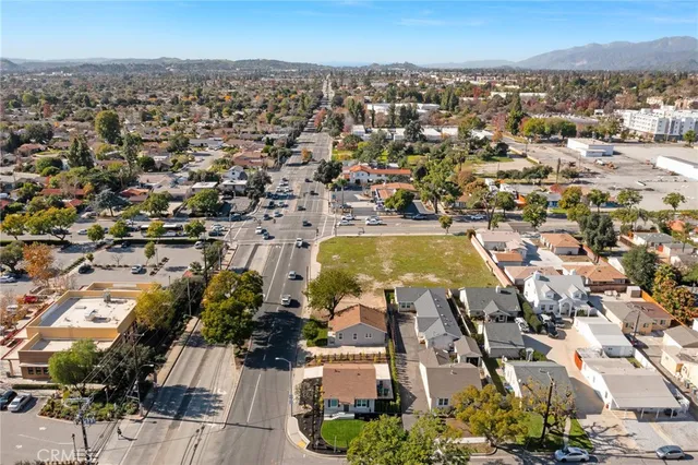 a view of a hallway with wooden floor and furniture