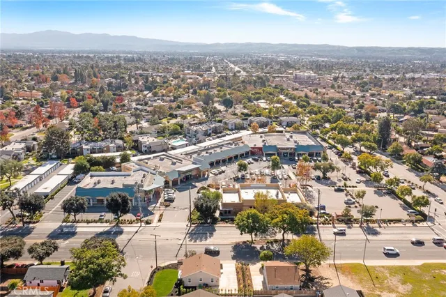 a living room with furniture a clock and a window
