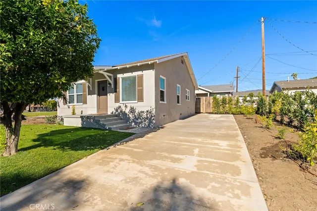 a living room with furniture a rug and white kitchen