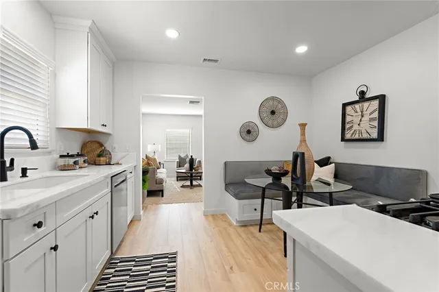 a living room with furniture potted plant and a flat screen tv