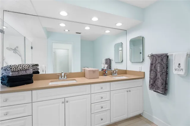 a bathroom with a double vanity sink and mirror