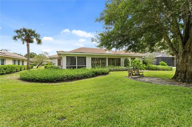 a view of a house with a big yard and potted plants