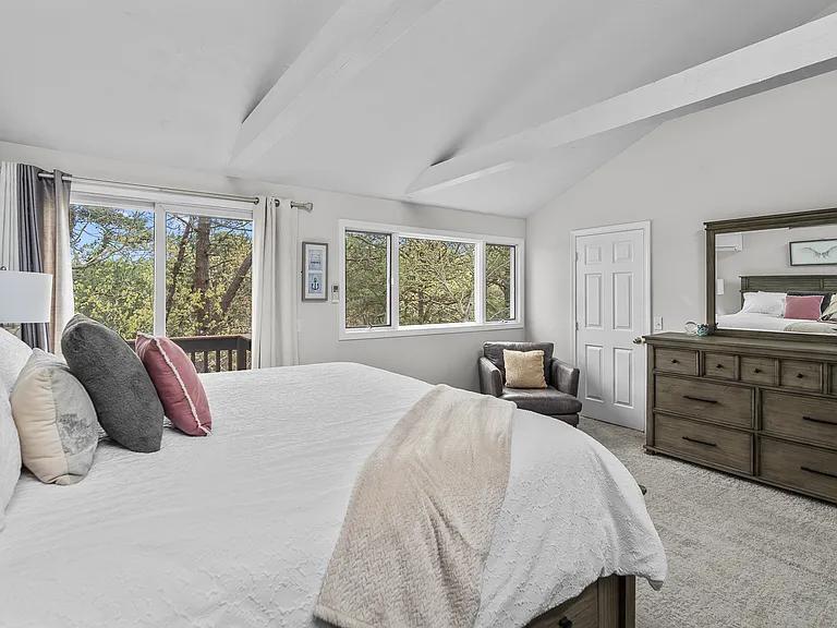 15 Riverview Avenue, Unit D Mashpee, MA 02649 - Photo 14 of 33 a bedroom with a bed and a dresser