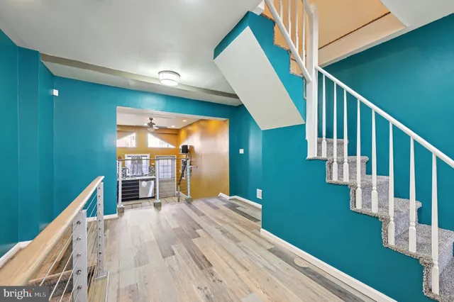 a view of entryway and hall with wooden floor