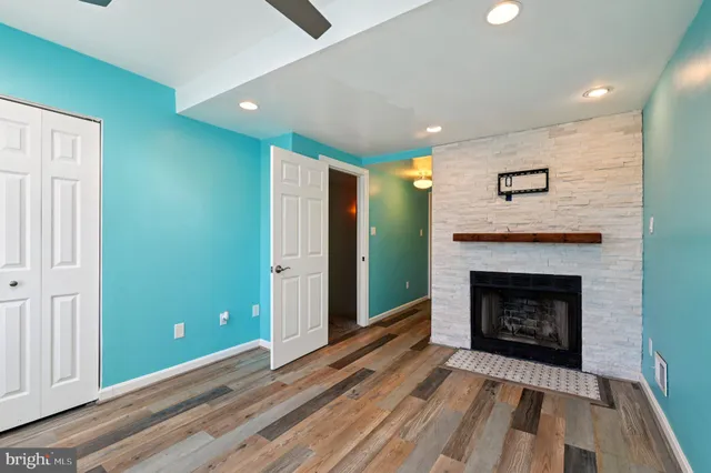 a living room with a fireplace and a wooden floor