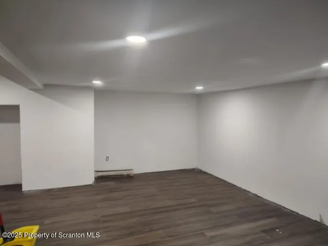 a kitchen with a refrigerator and a stove top oven