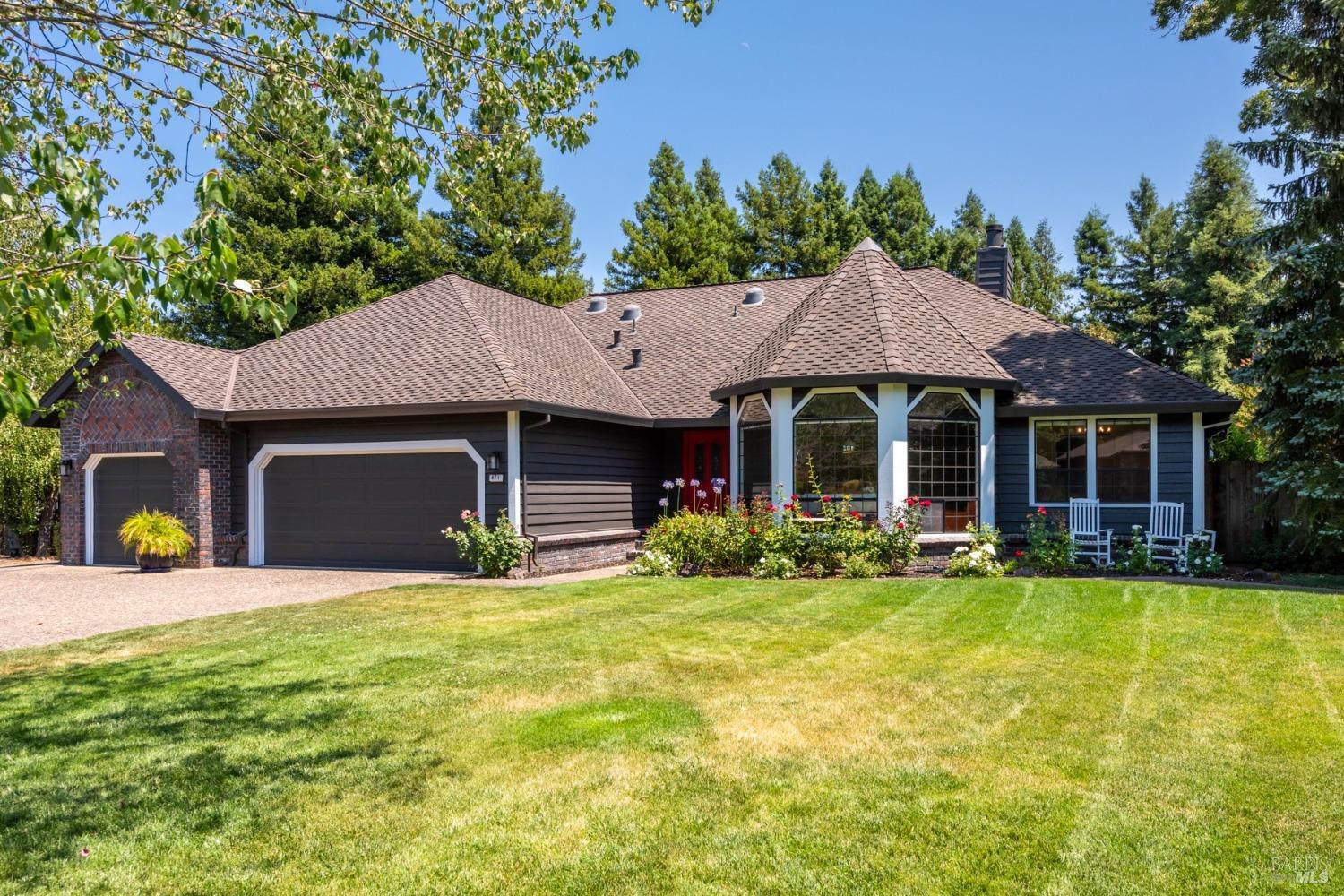 a view of a house with a yard and sitting area
