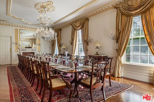 a living room with furniture a bed and a chandelier