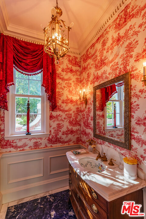 500 St Cloud Road Los Angeles, CA 90077 - Photo 14 of 59 a bathroom with a sink and a large mirror