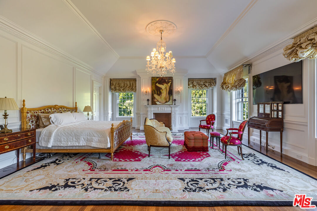 500 St Cloud Road Los Angeles, CA 90077 - Photo 19 of 59 a living room with furniture chandelier and a fireplace