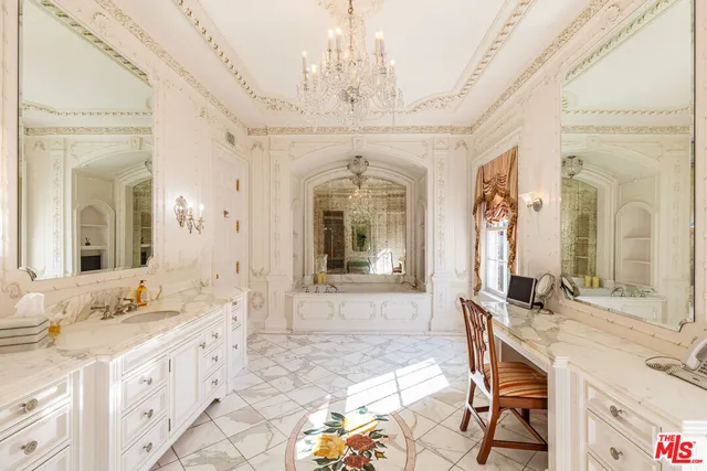 a spacious bedroom with a bed and wooden floor