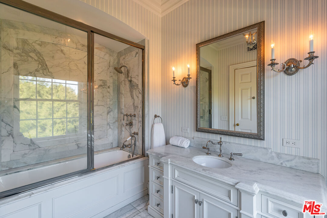 500 St Cloud Road Los Angeles, CA 90077 - Photo 27 of 59 a bathroom with a granite countertop sink mirror and a bath tub