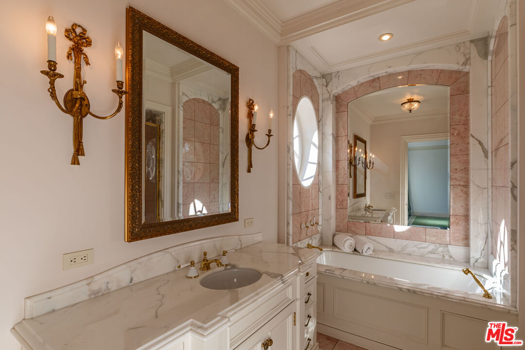500 St Cloud Road Los Angeles, CA 90077 - Photo 29 of 59 a bathroom with a sink and a mirror