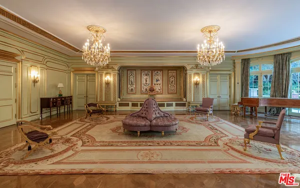 a view of a hallway with wooden floor and windows