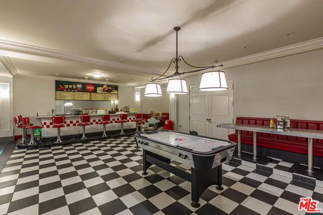 a balcony with wooden floor table and chairs