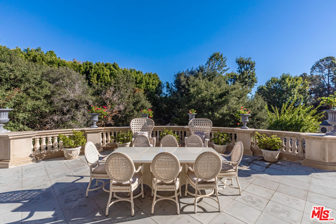 500 St Cloud Road Los Angeles, CA 90077 - Photo 44 of 59 a balcony with wooden floor table and chairs