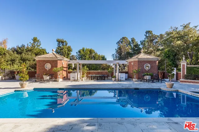 a view of a big building with big yard and large trees