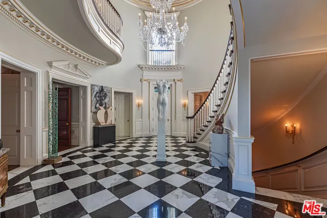 a living room with fireplace furniture and a chandelier