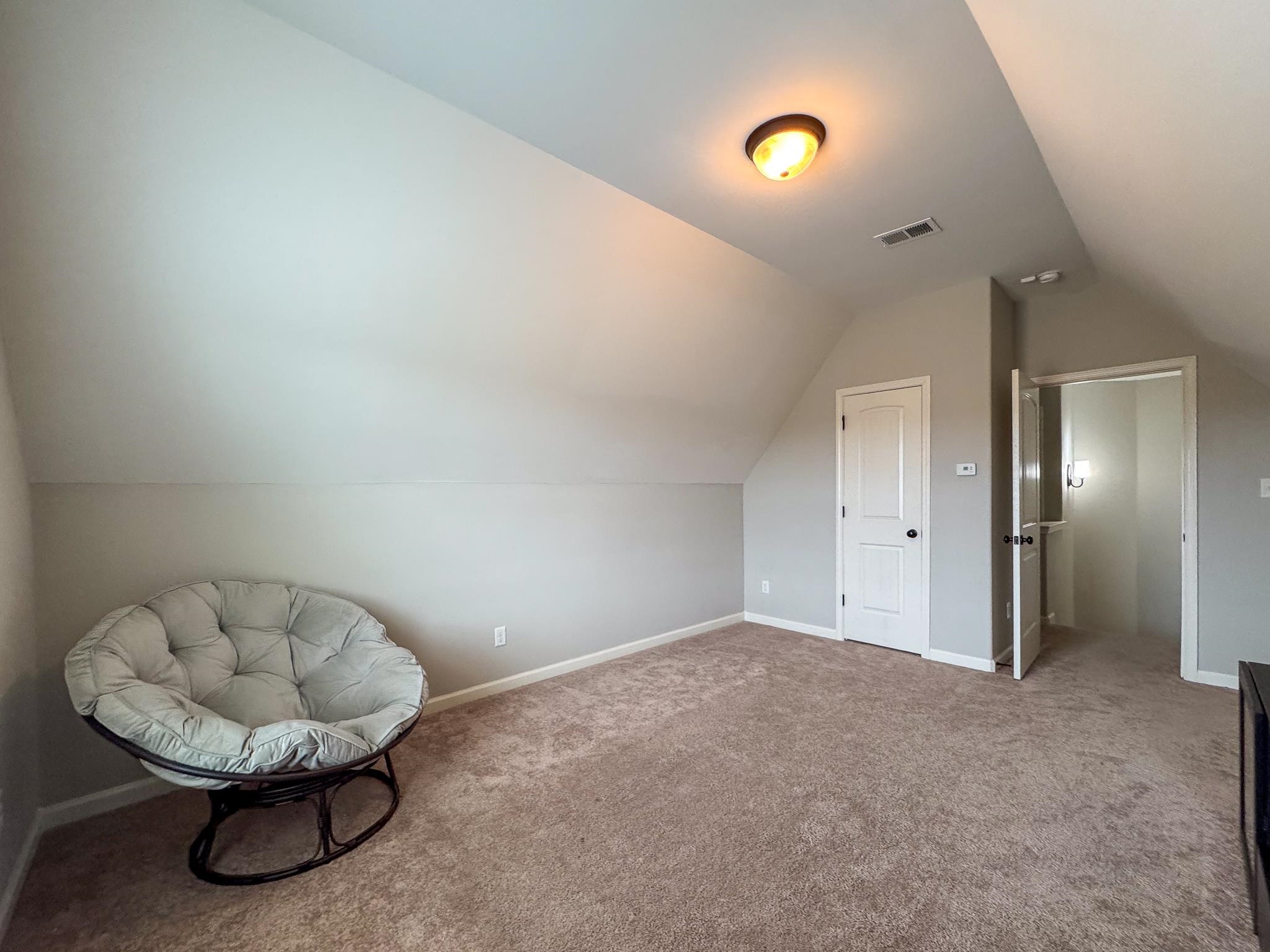 7754 Shadowcrest Road Memphis, TN 38125 - Photo 24 of 27 Sitting room featuring baseboards, lofted ceiling, carpet flooring, and visible vents