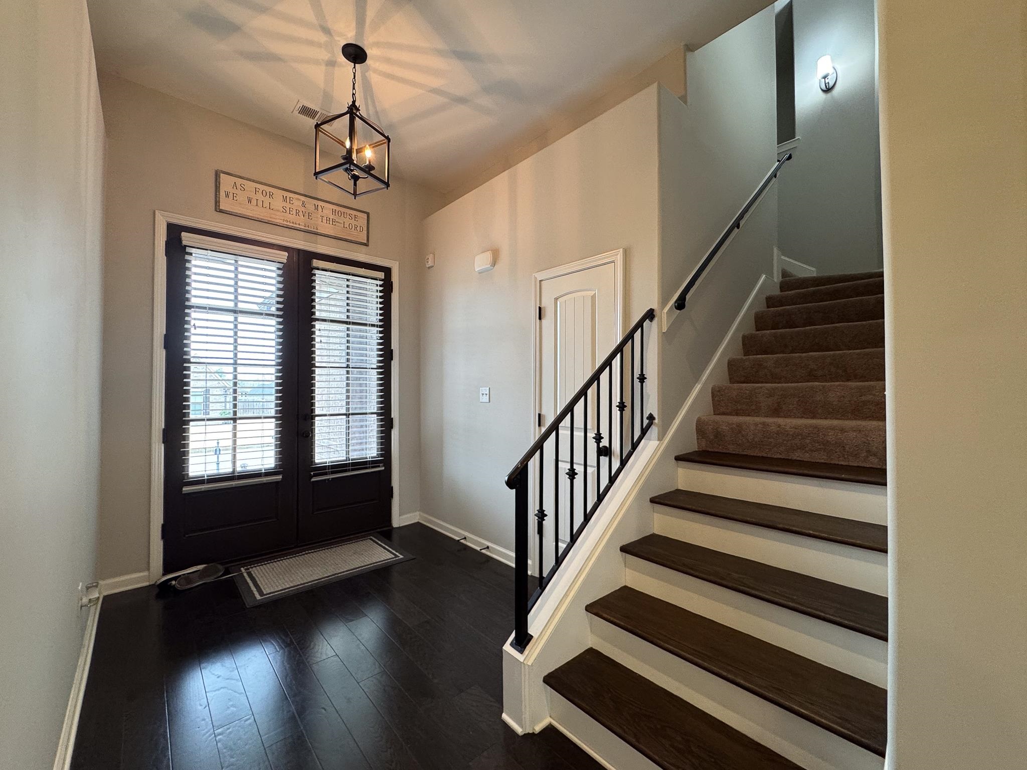 7754 Shadowcrest Road Memphis, TN 38125 - Photo 4 of 27 Foyer entrance featuring dark wood-style flooring, visible vents, baseboards, stairs, and a notable chandelier