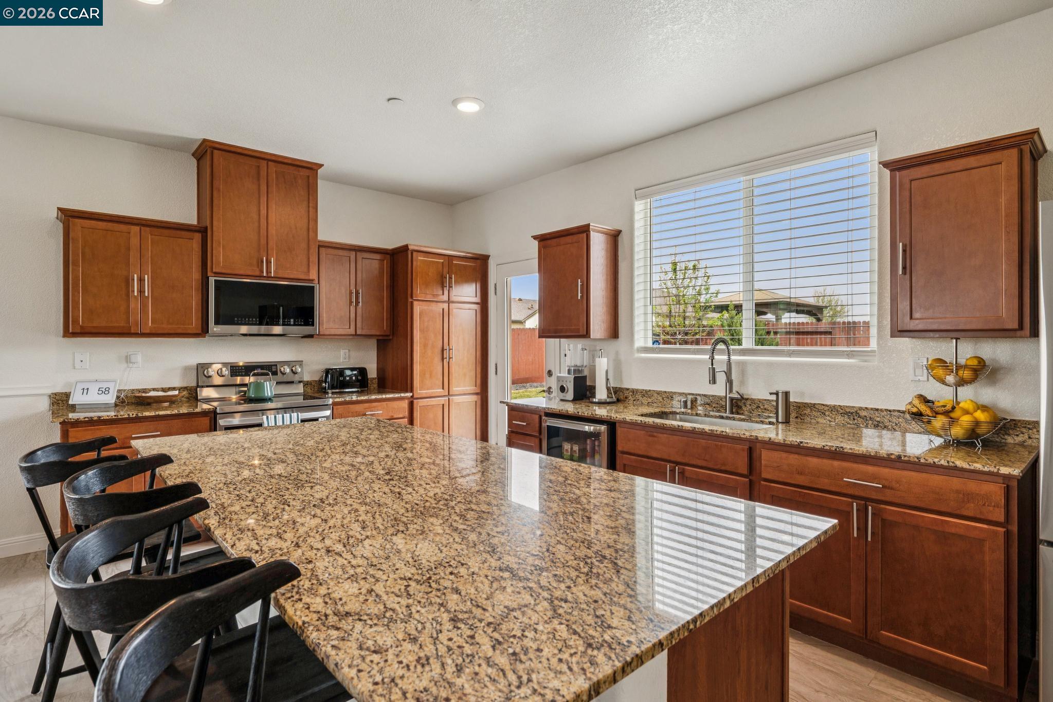 4748 Beacon Way Rio Vista, CA 94571 - Photo 11 of 35 a kitchen with stainless steel appliances granite countertop a stove top oven a sink dishwasher a microwave oven with granite countertops and cabinets
