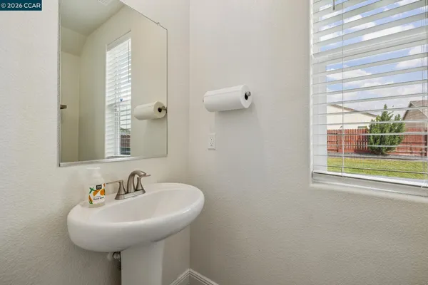 a bathroom with a sink a mirror and a window